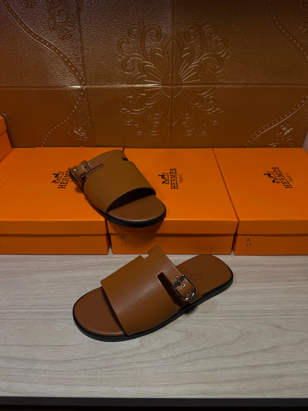 Hermes leather slide sandals with silver buckle hardware, dark brown