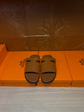 Hermes leather slide sandals with wide strap and metal buckle, dark brown