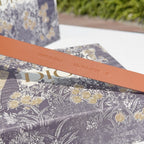 Tan leather belt with 'MADE IN ITALY' stamp and model code