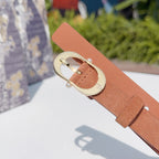 Tan leather belt with gold-tone oval buckle and pearl-like stud details