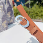Dior belt with tan strap and silver buckle, end section visible