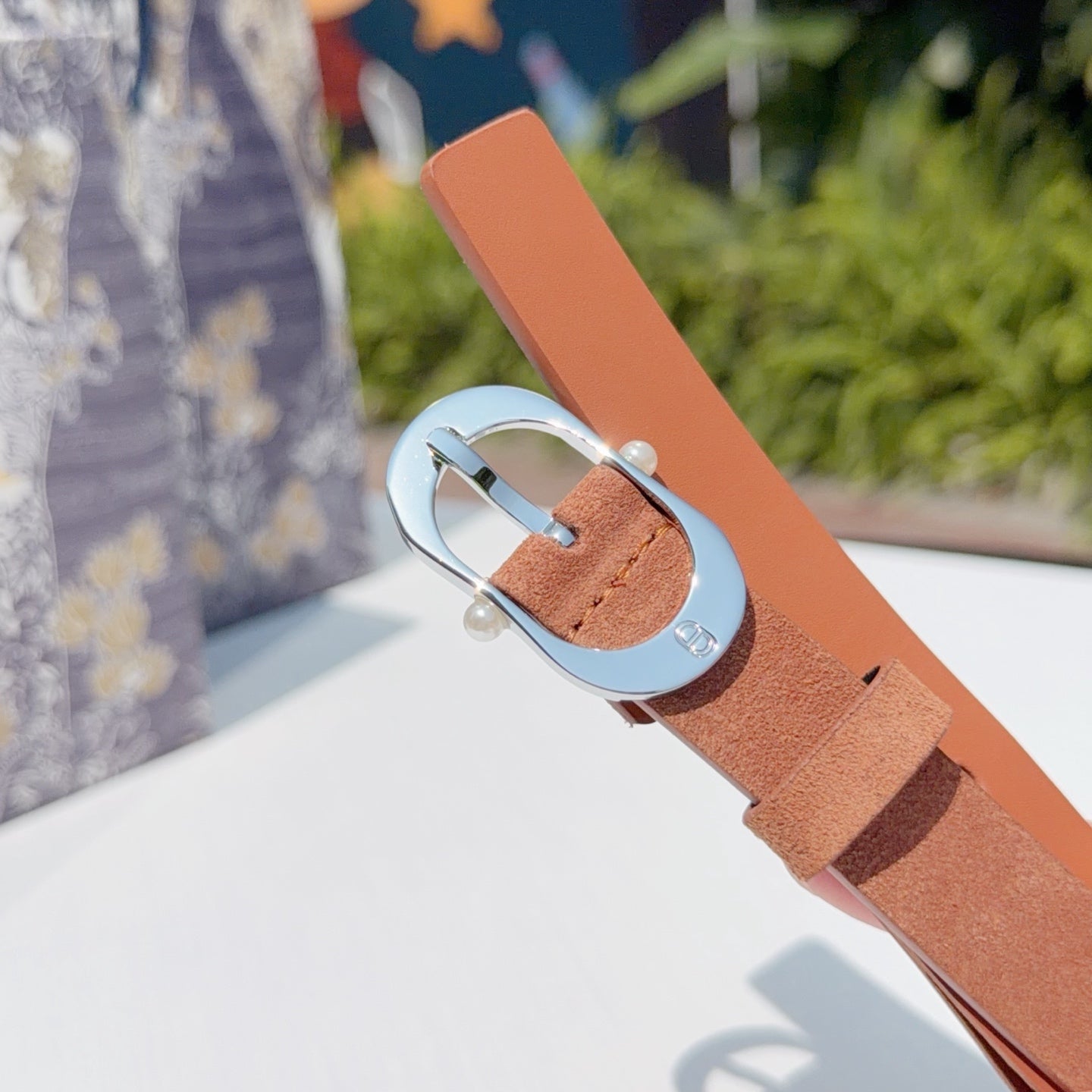 Dior belt with tan strap and silver buckle, end section visible