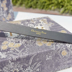 Dior belt strap close-up with “Christian Dior” and “PARIS” text