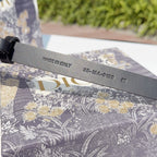 Dark leather belt with 'MADE IN ITALY' and code-stamped underside