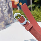Reddish-brown leather belt with round silver buckle and metal keeper