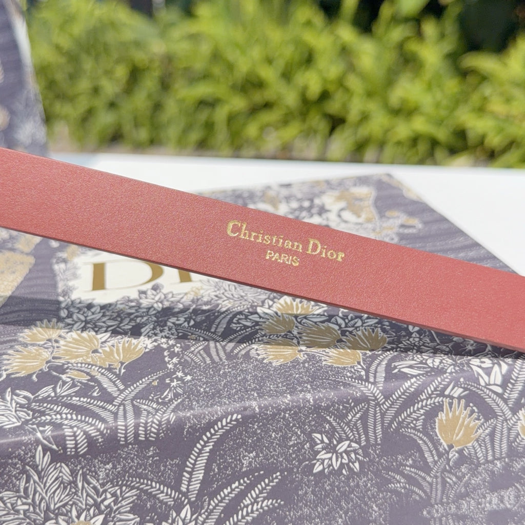 Red leather belt with printed Christian Dior Paris on strap