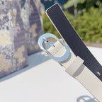 Dior belt with cream strap and silver buckle over dark backing fabric
