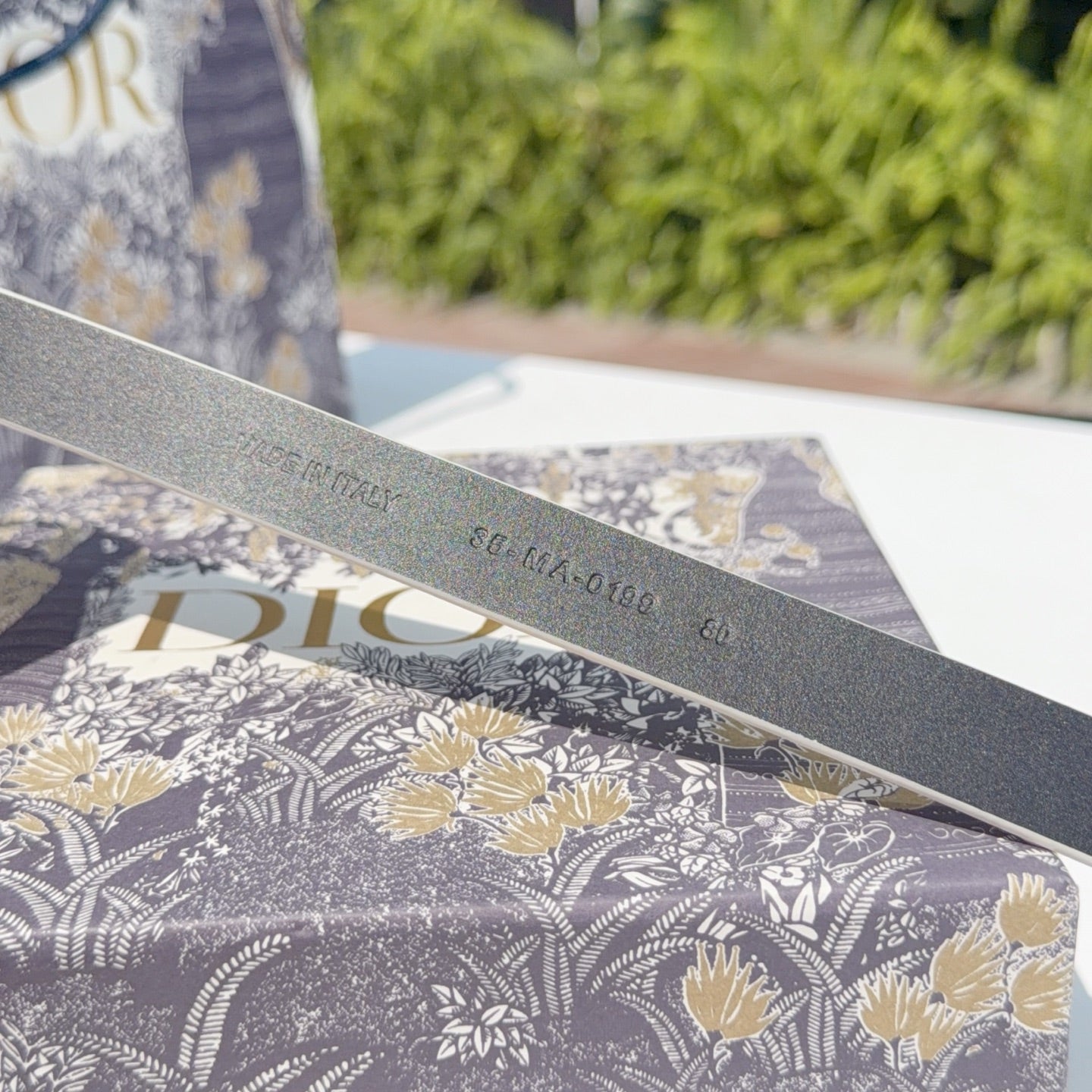 Dior belt strap underside with embossed text along the leather