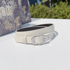 Dior belt with cream strap and silver oval buckle, laid flat