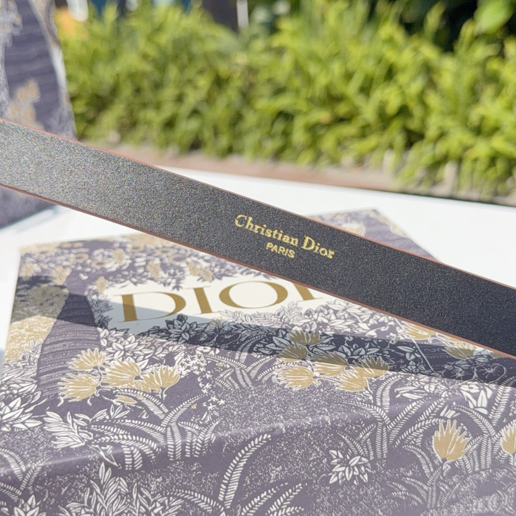 Dark belt strap with embossed 'Christian Dior' and 'PARIS' lettering