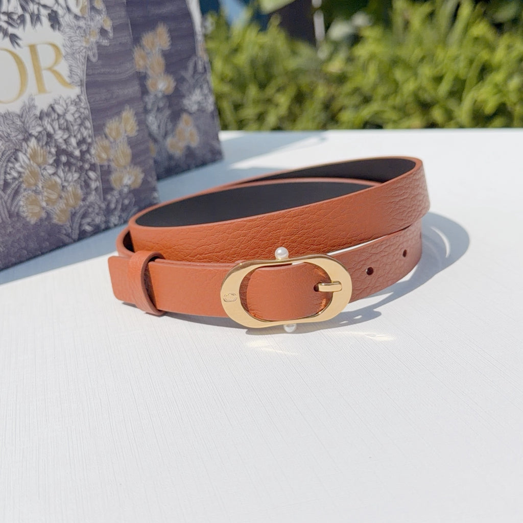 Orange textured leather belt with gold-tone oval buckle and single prong