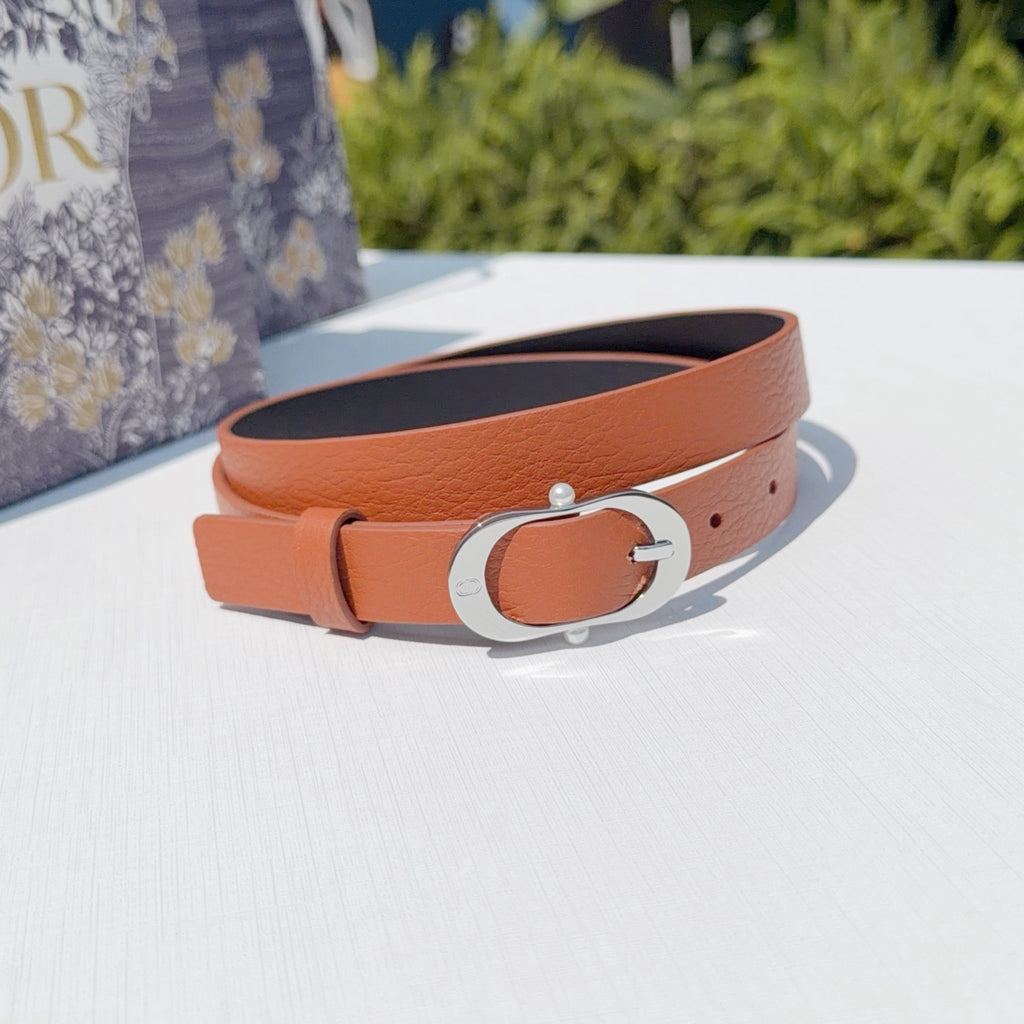 Leather belt with orange strap and silver-toned oval buckle, front view