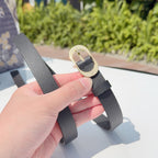 Dior belt clasp detail: dark gray leather strap with gold-tone buckle ring and pin.