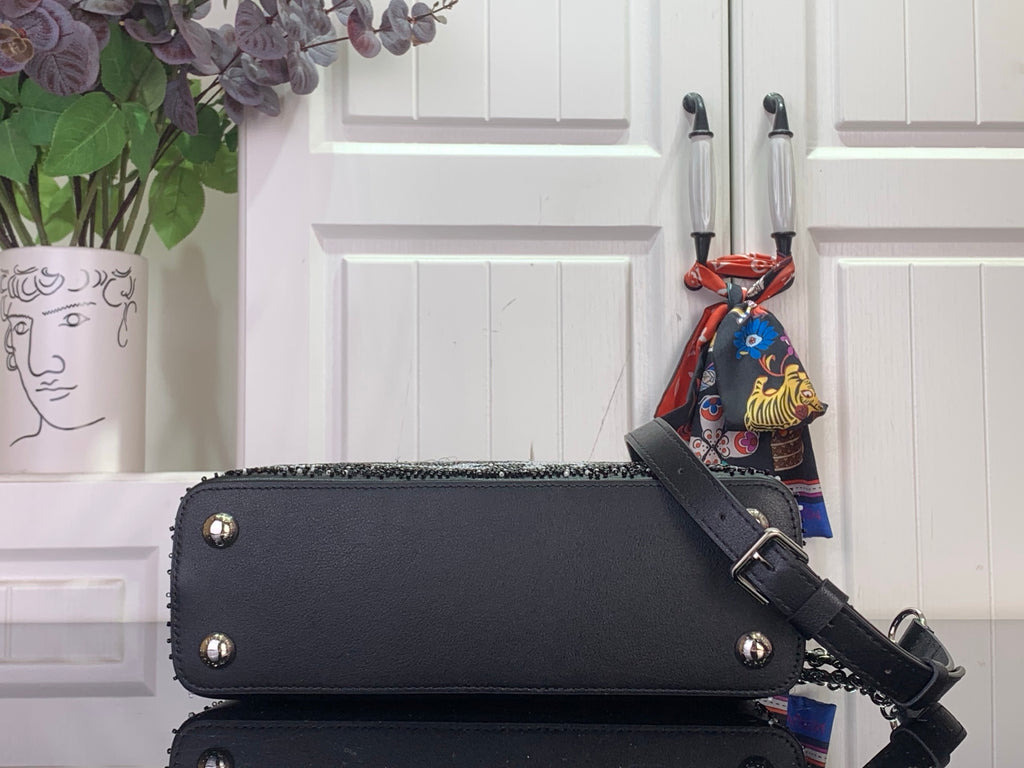 Louis Vuitton handbag, black leather with bottom studs and crossbody strap