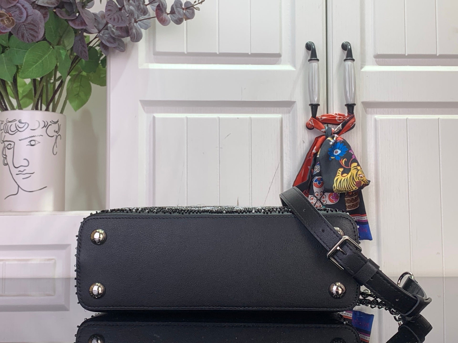 Louis Vuitton handbag, black leather with bottom studs and crossbody strap