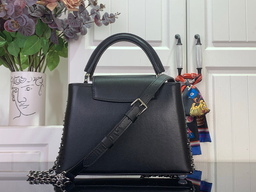 Louis Vuitton handbag, black leather top-handle with front strap and silver clasp