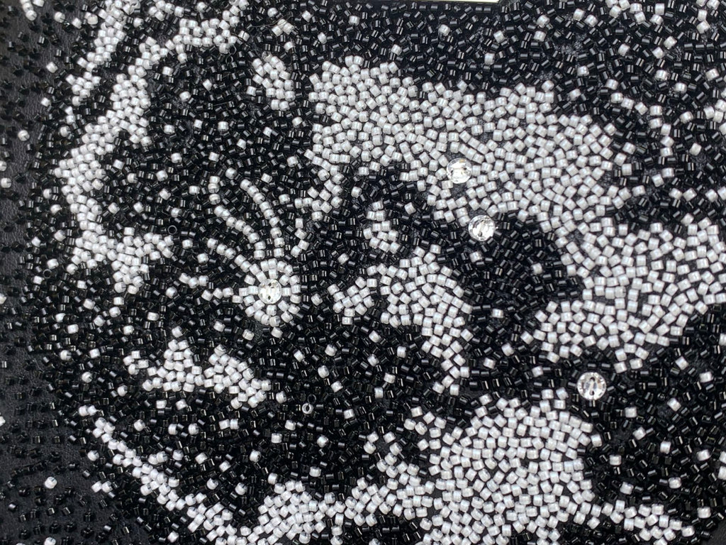 Black sequin fabric with white graphic pattern on Louis Vuitton handbag