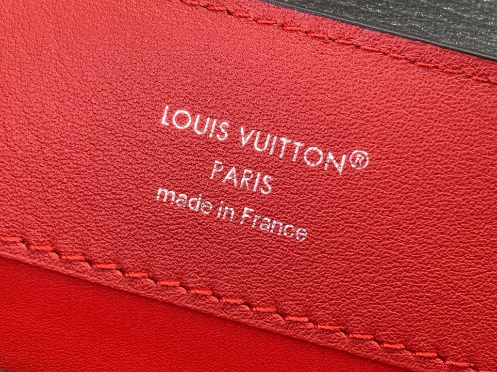 Red leather Louis Vuitton label with “Louis Vuitton” and “Paris” text