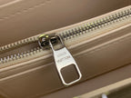 Louis Vuitton zipper pull with rectangular metal tag on light leather