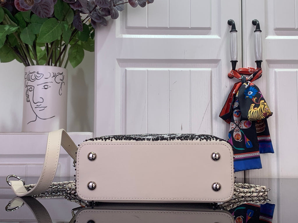 Louis Vuitton beaded handbag with front flap, silver snap studs and crossbody chain
