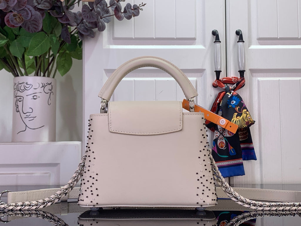 Louis Vuitton beaded handbag with front handle and silver chain shoulder strap