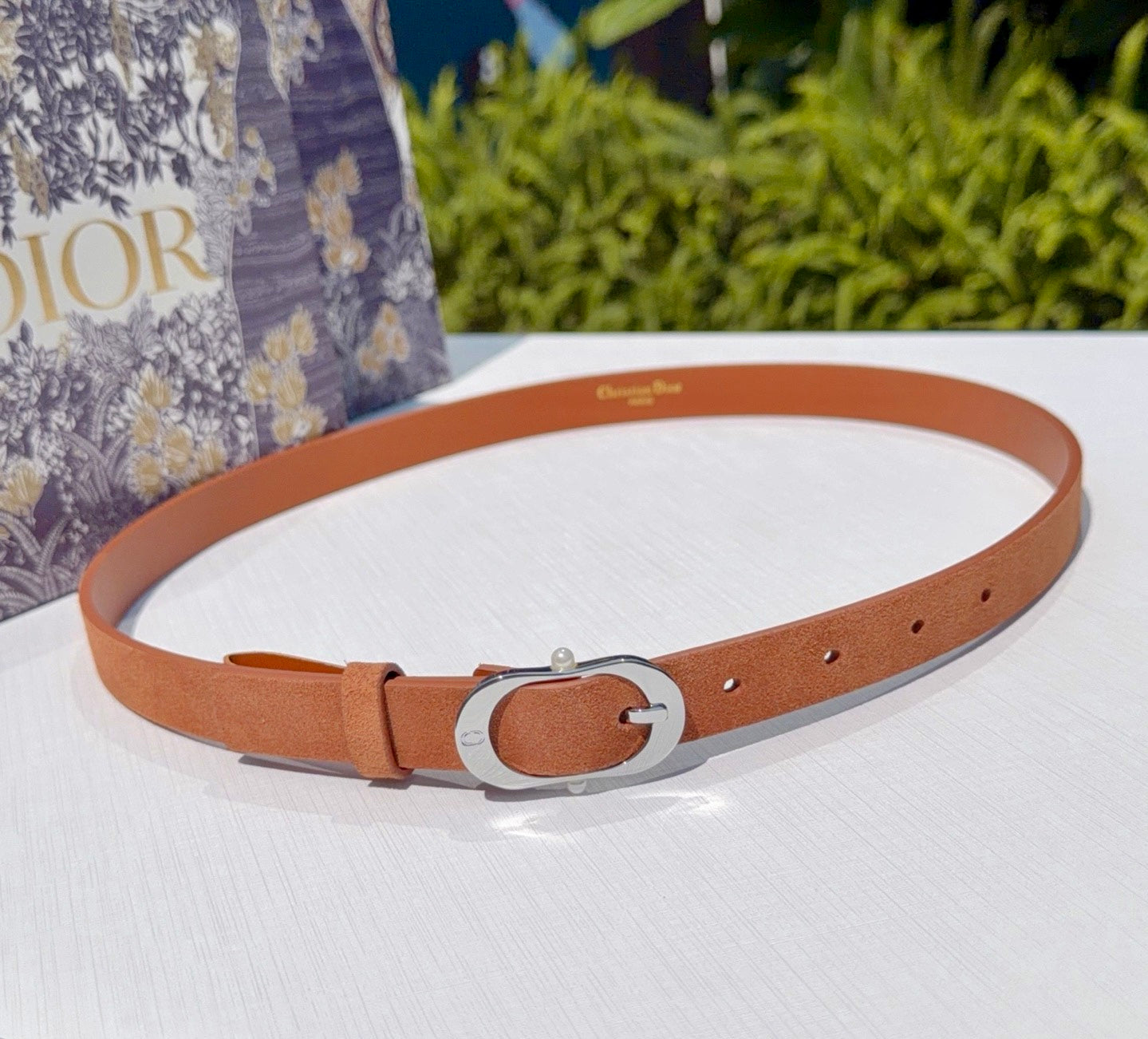 Dior belt with tan leather strap and silver oval buckle hardware