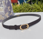 Dior belt in dark leather with gold oval buckle and punched holes