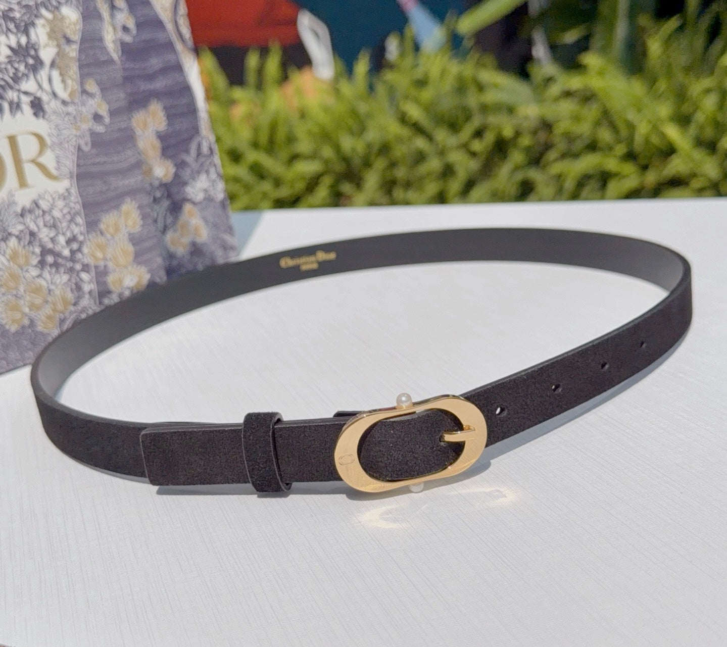 Dior belt in dark leather with gold oval buckle and punched holes