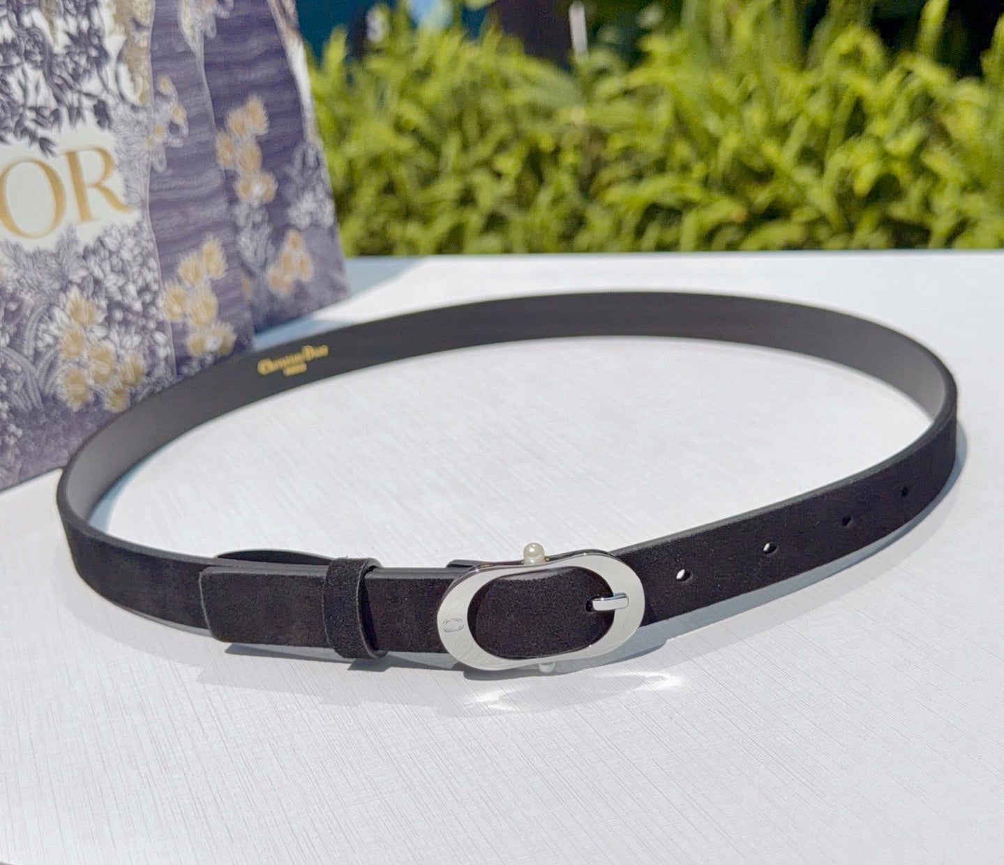 Dior belt with dark strap and silver oval buckle, with punched holes