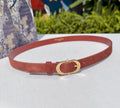 Tan leather belt with gold-tone circular buckle and adjustable holes