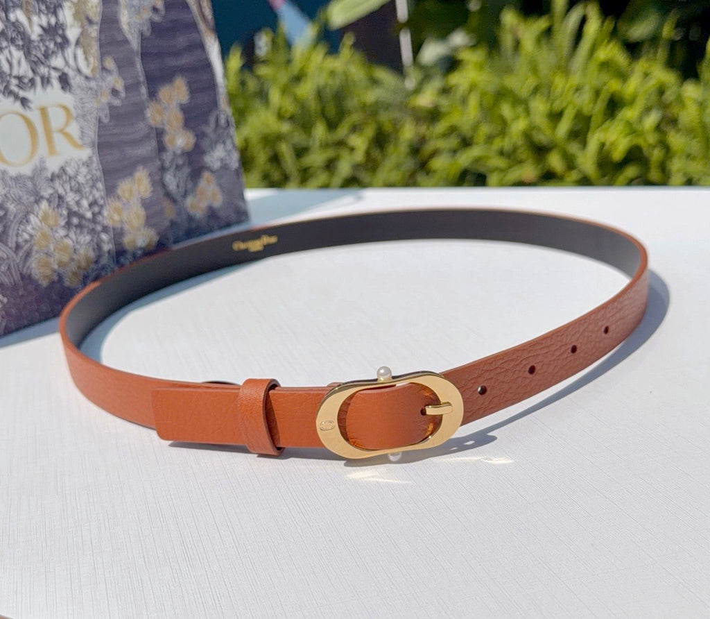 Orange leather belt with gold-tone buckle and small logo pin detail