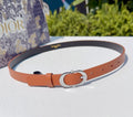 Dior leather belt with orange strap, silver-toned oval buckle, and punched holes