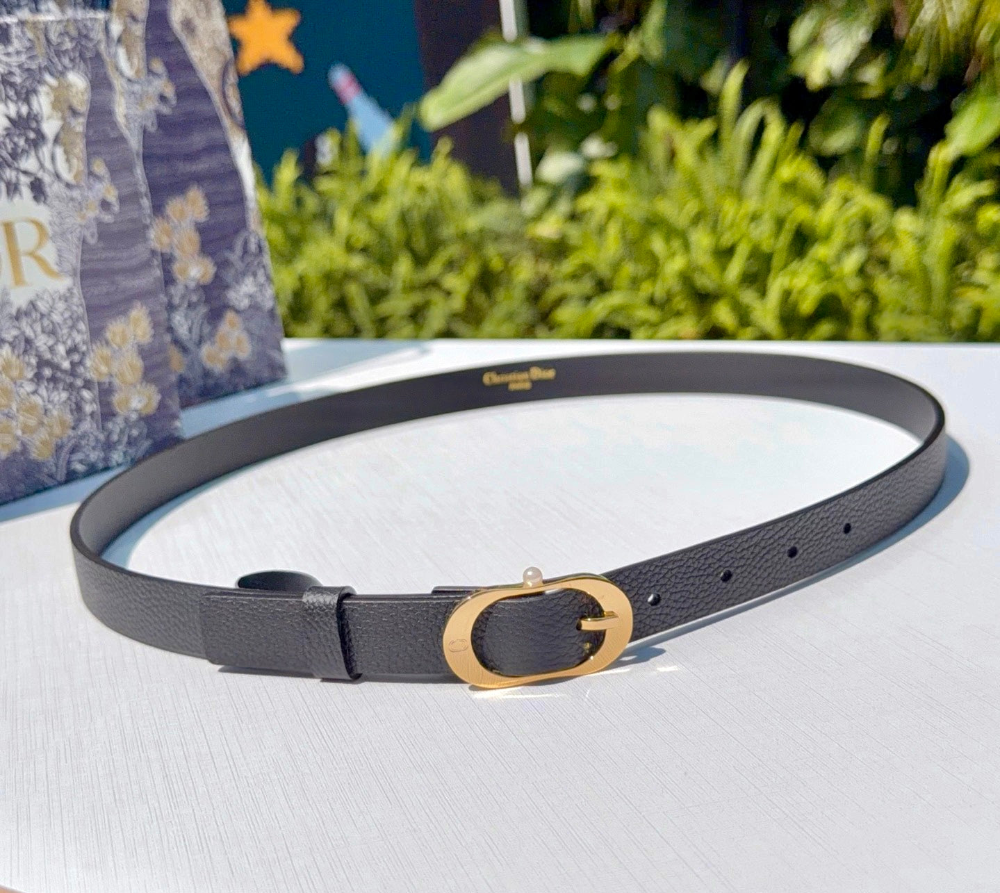 Dior belt in dark gray leather with gold-tone double G buckle and perforation holes.