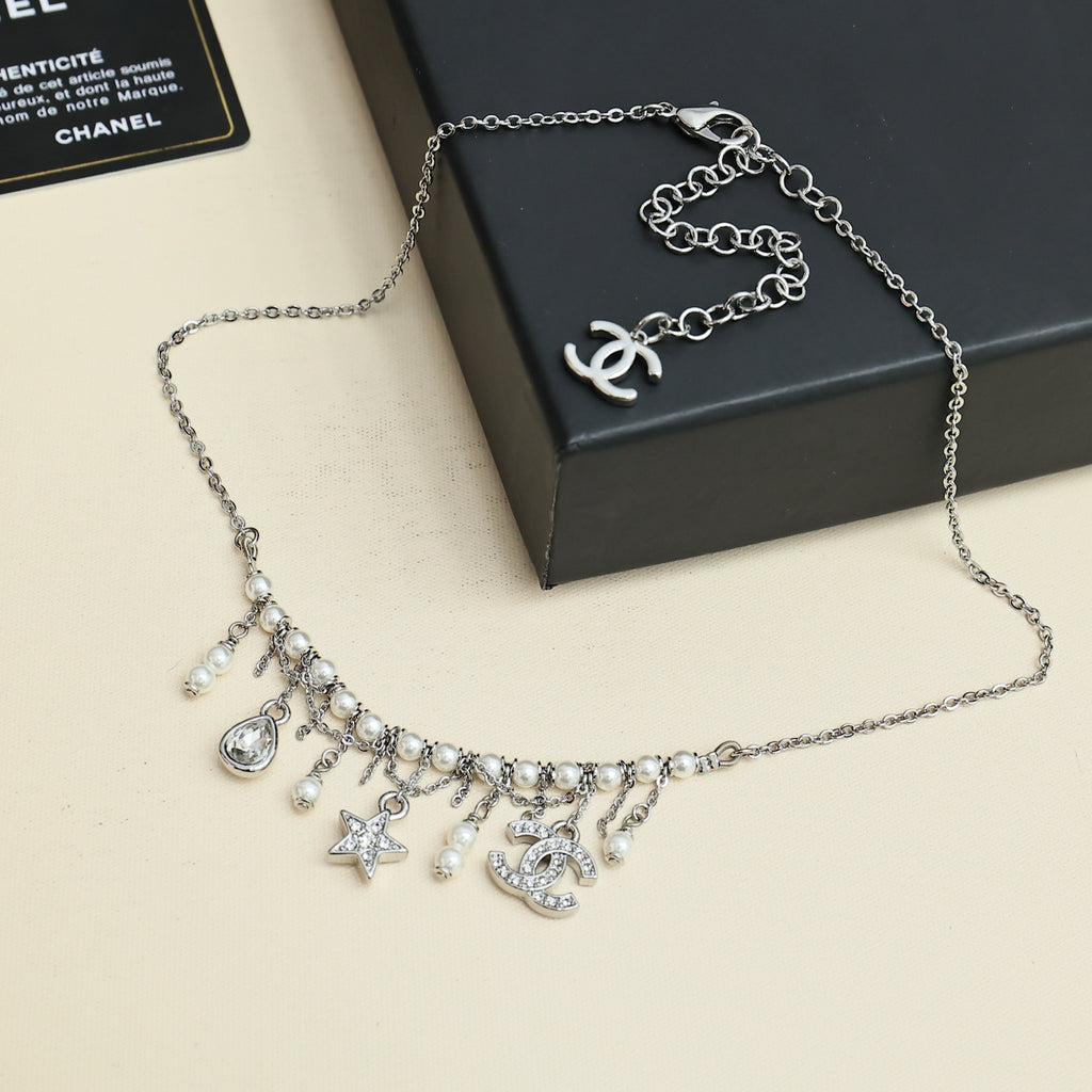 Silver-tone charm necklace with logo pendant, pearl and star dangles
