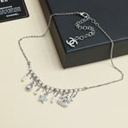 Silver-tone charm necklace with logo pendant, pearl and star dangles