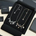Silver-tone charm necklace with star and pearl dangle pendants, short chain