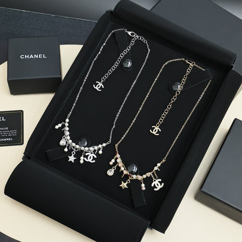 Silver-tone charm necklace with star and pearl dangle pendants, short chain