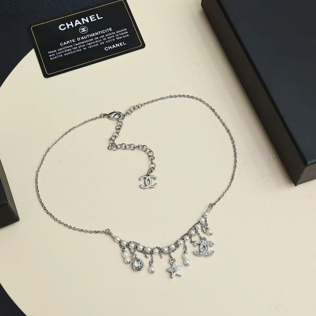 Silver-tone charm necklace with logo pendant and star-and-pearl drop charms