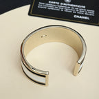 Silver-tone cuff bracelet with CHANEL logo details, open cuff view