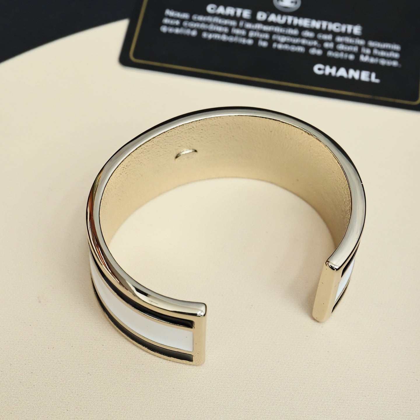 Silver-tone cuff bracelet with CHANEL logo details, open cuff view
