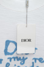 White T-shirt with Dior hang tag over blue embroidered text