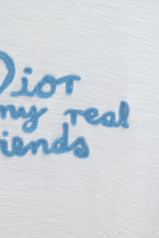 White T-shirt close-up of blue embroidered 'my real friends' text