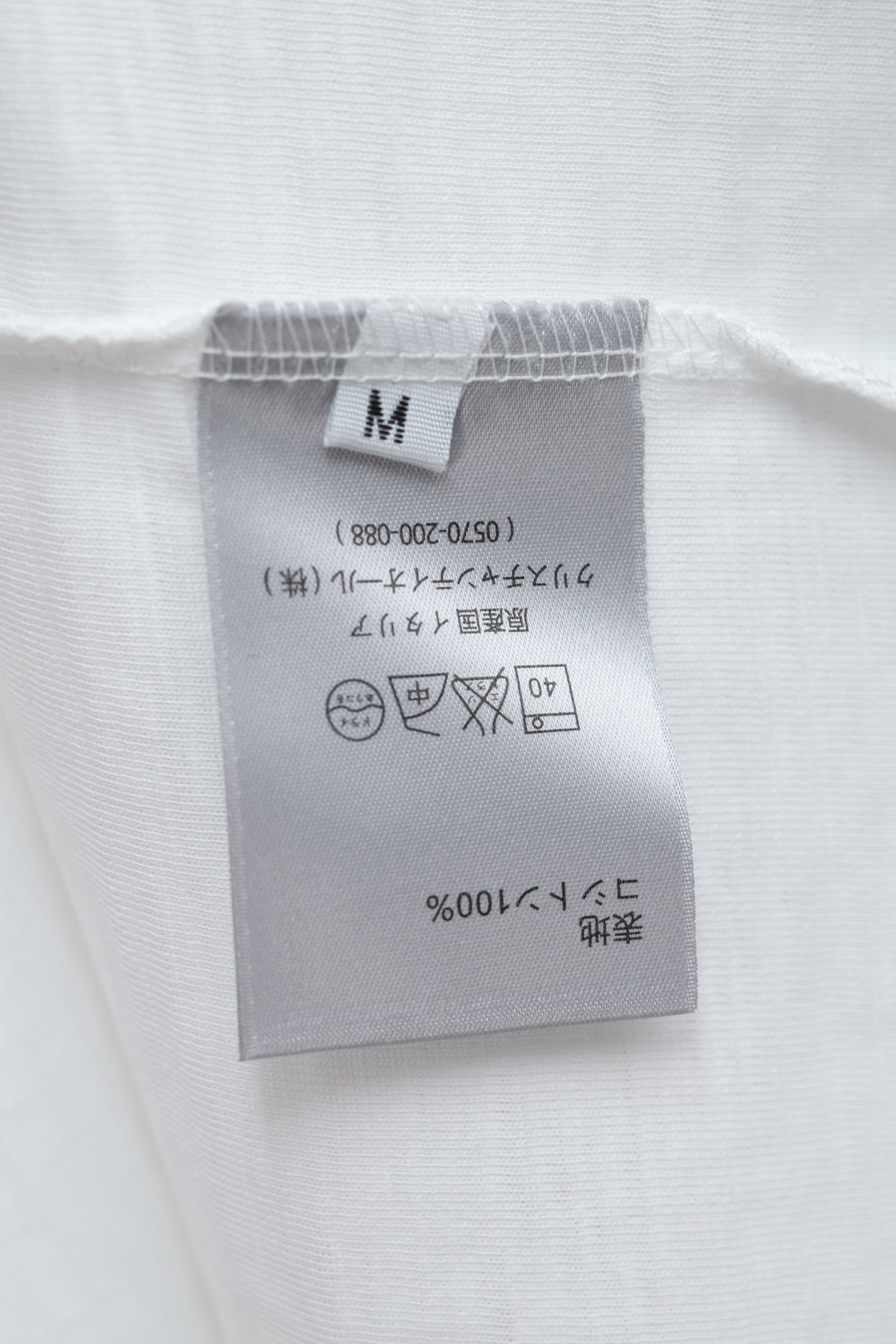 White T-shirt size and care label at hem