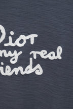 Dark blue T-shirt close-up showing partial white slogan text