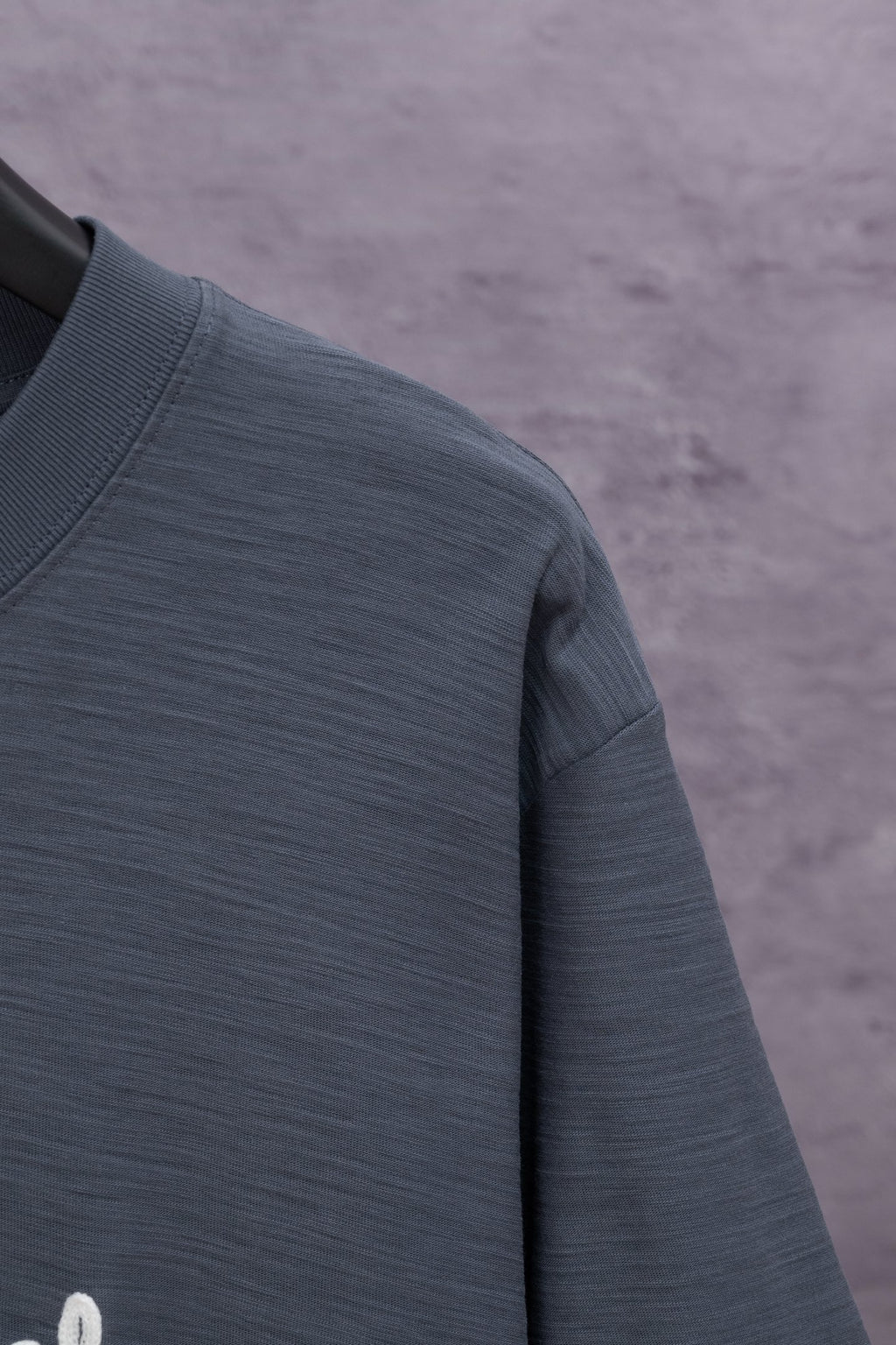 Dark blue short-sleeve T-shirt fabric close-up, crewneck seam