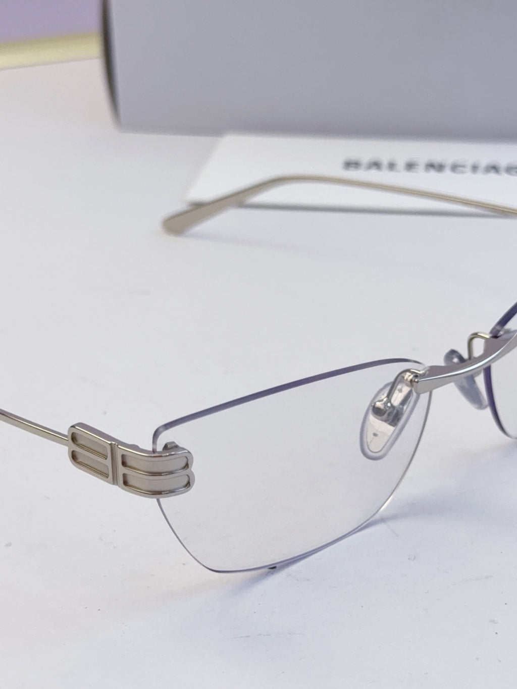 Balenciaga eyeglasses close-up: clear lenses, metal bridge with bar detail