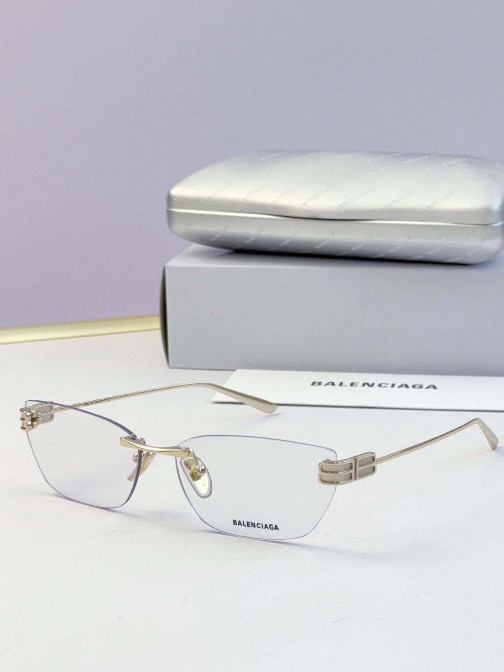 Balenciaga eyeglasses with clear lenses, light metal frame and logo temples