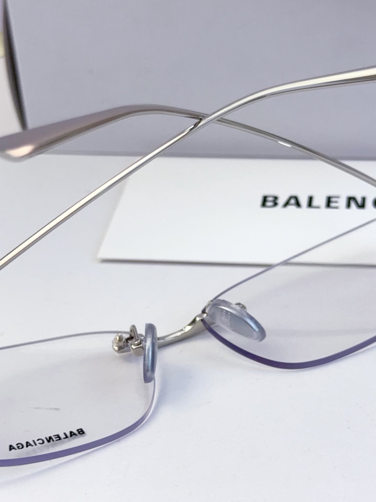 Balenciaga eyeglasses close-up with clear lenses, thin metal frame and nose bridge