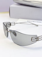 Balenciaga sunglasses with dark lenses and silver-gray frame, visible logo bar detail