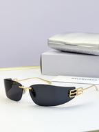 Balenciaga sunglasses with gold metal frame and dark tinted lenses, logo bar detail